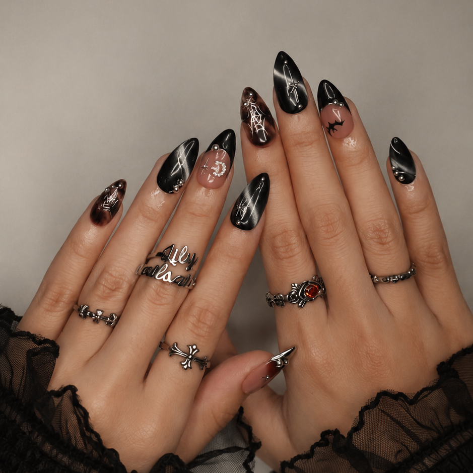 Batwing handmade gothic Halloween press-on nails — medium almond set in nude, black cat-eye and smoky brown with silver chrome tips, bats, rhinestone crescent moon and silver spiderwebs.