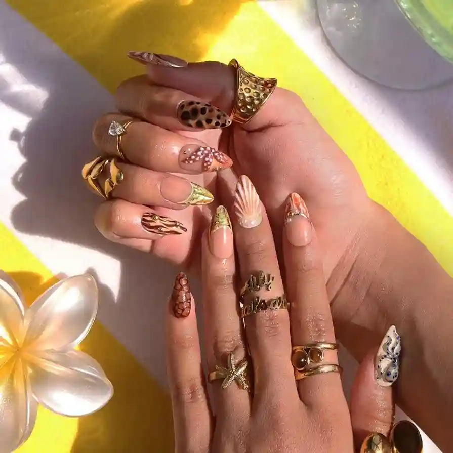Handmade summer press-on nails with seashell art, blue-ringed octopus, starfish and leopard cowrie print by Lily Nails Art