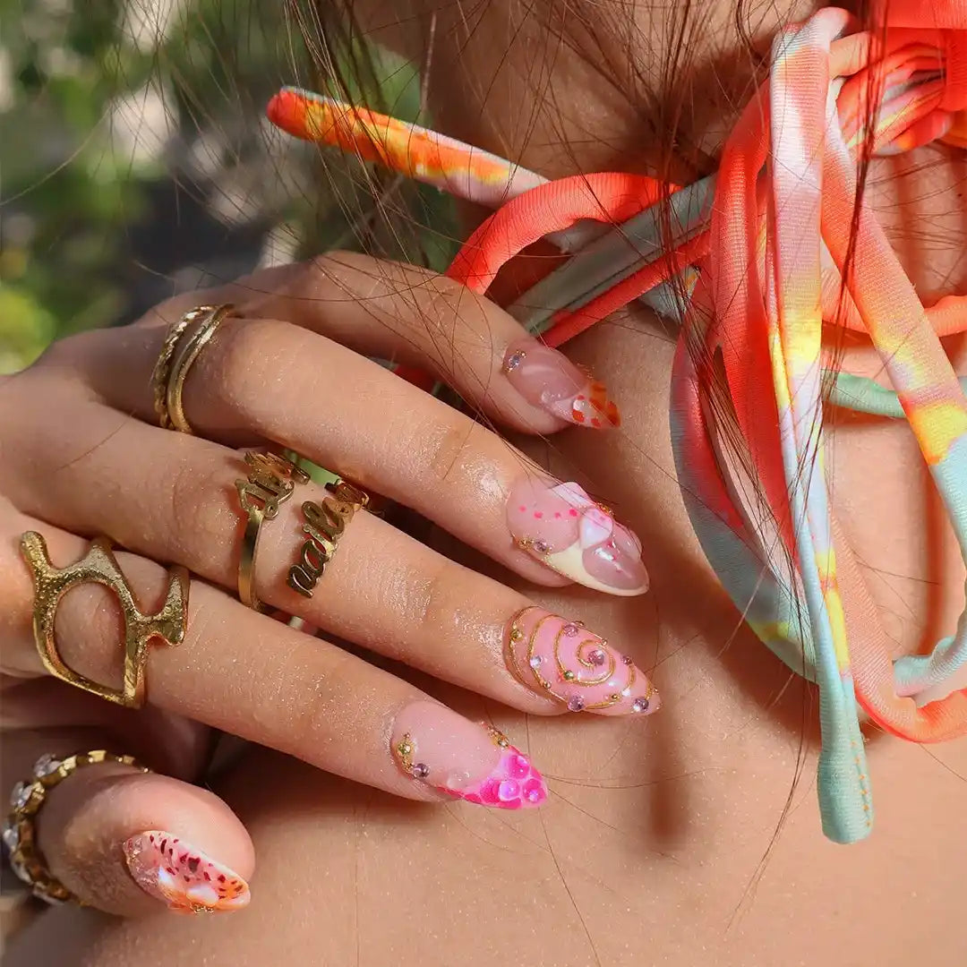 Handmade summer press-on nails with coral pink blooms, 3D floral centerpiece, leopard dots and gold spiral details by Lily Nails Art