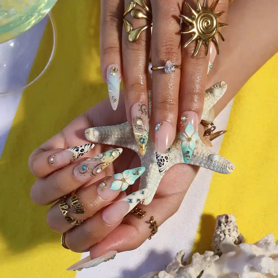 Handmade luxury summer stiletto press-on nails with aqua florals, 3D iridescent bloom, black animal print and gold crystal embellishments by Lily Nails Art