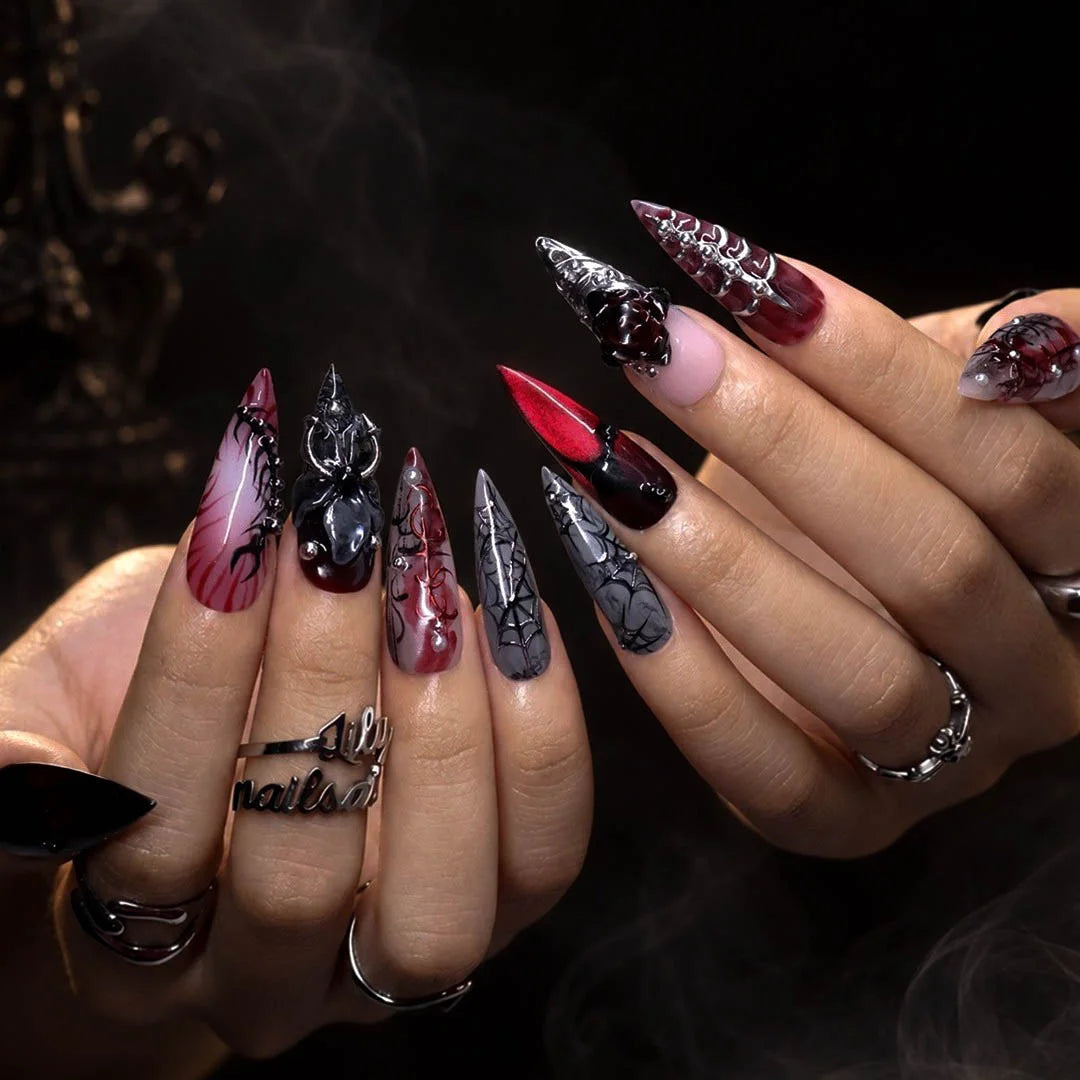 Velvet Bite gothic press on nails in blood red, black and smoky grey with a 3D spider, spiderwebs, black rose, silver studs and thorny vines — handmade Halloween press on nails, long stiletto fake nails and vampire gothic nail art.