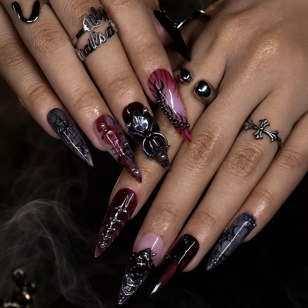 Velvet Bite gothic press on nails in blood red, black and smoky grey with a 3D spider, spiderwebs, black rose, silver studs and thorny vines — handmade Halloween press on nails, long stiletto fake nails and vampire gothic nail art.