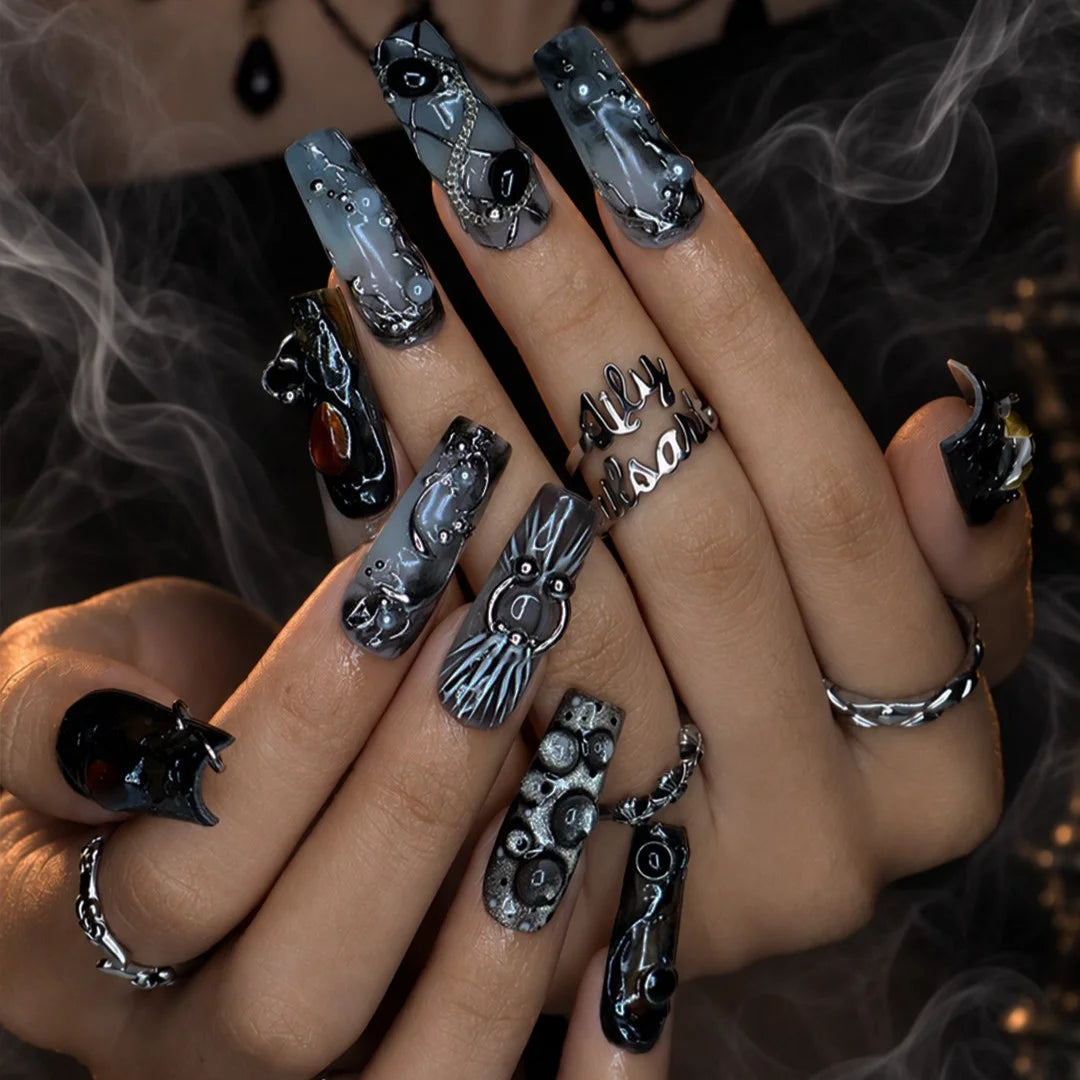 Alchemy gothic press on nails in smoky grey, black and olive with amber and onyx cabochons, silver hoops, chains and bubbling pearl textures — handmade Halloween press on nails, long square fake nails and witchy gothic nail art.