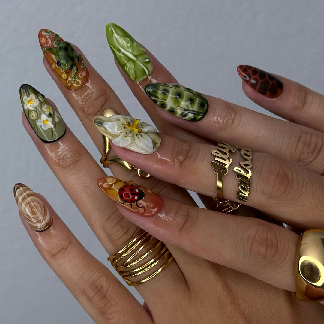 3D enchanted forest press-on nails with sculpted mushrooms, frogs, ladybugs, flowers, and woodland textures in earthy greens, browns, and reds — handmade medium almond nails — perfect for fairytale nail art, mystical styles, or fall luxury looks.