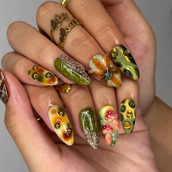 3D forest-inspired press-on nails with sculpted mushrooms, fruits, metallic leaves, and organic earthy textures in amber, moss green, and deep brown tones — luxury handmade long almond nails — perfect for autumn styles, enchanted woodland looks, or mystical nail art for fall
