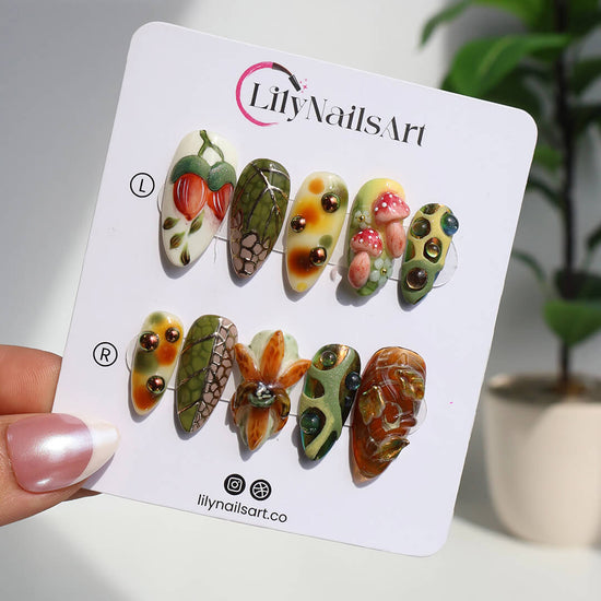 3D forest-inspired press-on nails with sculpted mushrooms, fruits, metallic leaves, and organic earthy textures in amber, moss green, and deep brown tones — luxury handmade long almond nails — perfect for autumn styles, enchanted woodland looks, or mystical nail art for fall