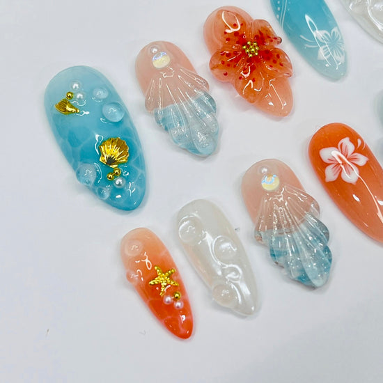 Handmade Tropical Ocean Press-On Nails – vibrant blue and coral tones with 3D seashells, flowers, starfish, and pearl accents. Perfect for  summer holidays, birthdays, vacations, or as a unique gift for her.