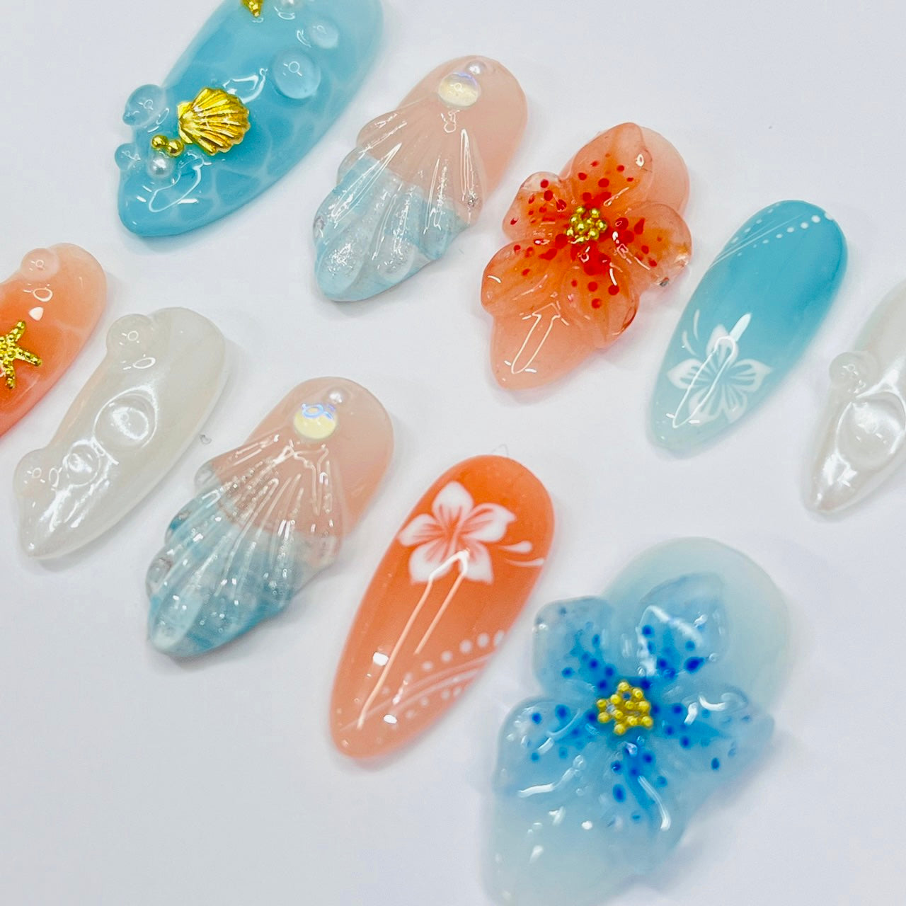 Handmade Tropical Ocean Press-On Nails – vibrant blue and coral tones with 3D seashells, flowers, starfish, and pearl accents. Perfect for  summer holidays, birthdays, vacations, or as a unique gift for her.