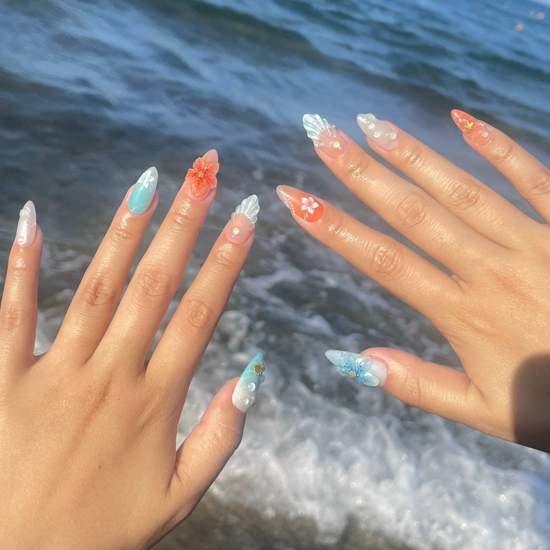 Handmade Tropical Ocean Press-On Nails – vibrant blue and coral tones with 3D seashells, flowers, starfish, and pearl accents. Perfect for  summer holidays, birthdays, vacations, or as a unique gift for her.