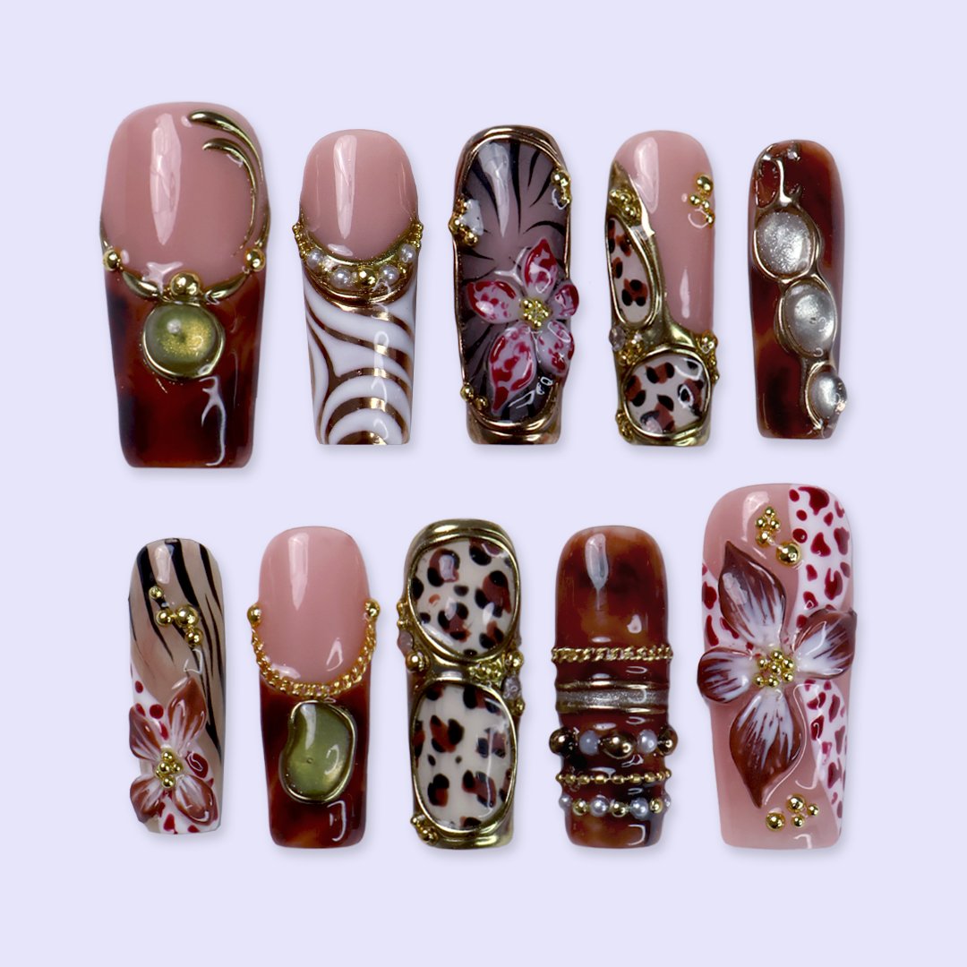 Zinfandel handmade fall press-on nails — maximalist long square set in nude, tortoiseshell and cream with 3D red-and-white orchids, olive and gold cat-eye cabochons, leopard and zebra prints, gold chains and pearl accents.