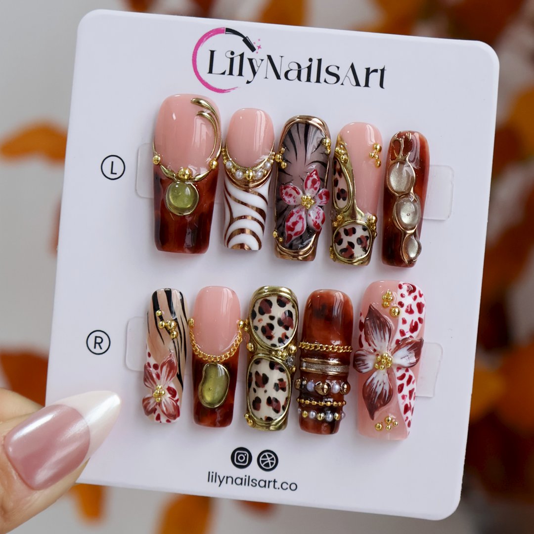 Zinfandel handmade fall press-on nails — maximalist long square set in nude, tortoiseshell and cream with 3D red-and-white orchids, olive and gold cat-eye cabochons, leopard and zebra prints, gold chains and pearl accents.