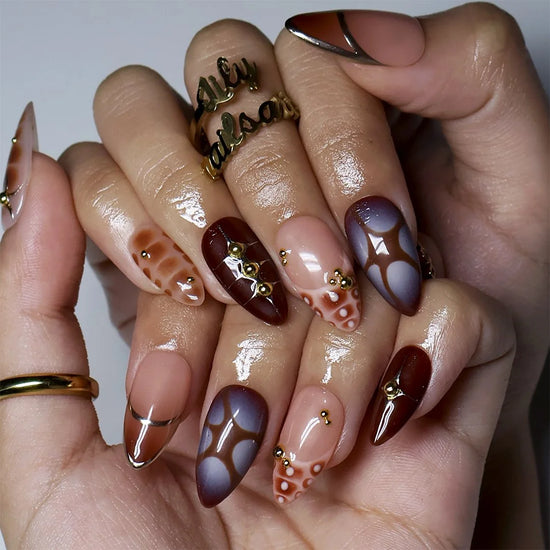 Brown and gold almond press on nails worn on hand