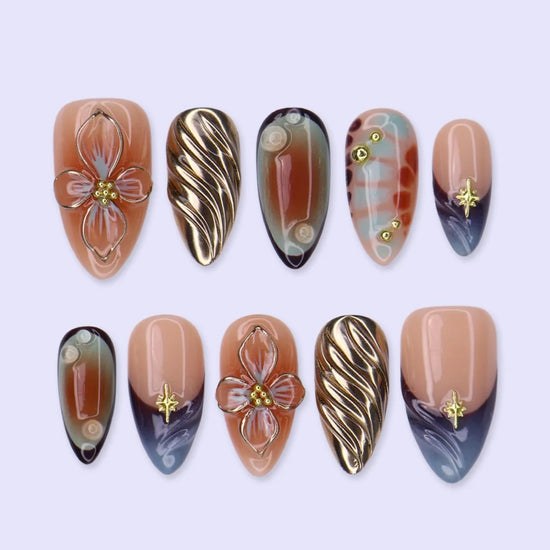 Athena handmade press on nails in nude, blue-grey and terracotta with 3D gold lilies and star charms