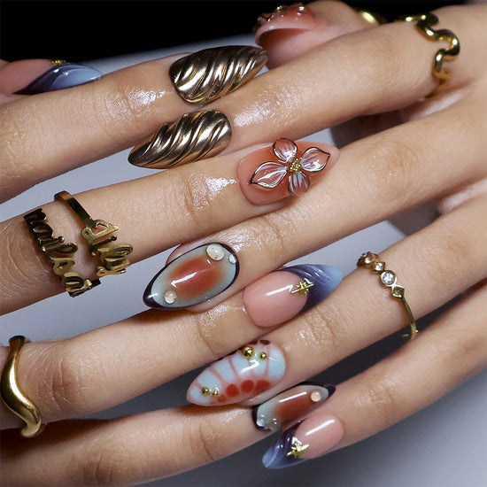 Athena handmade fall Y2K press-on nails — almond set in nude, blue-grey and terracotta with 3D gold lilies, chrome waves and star charms