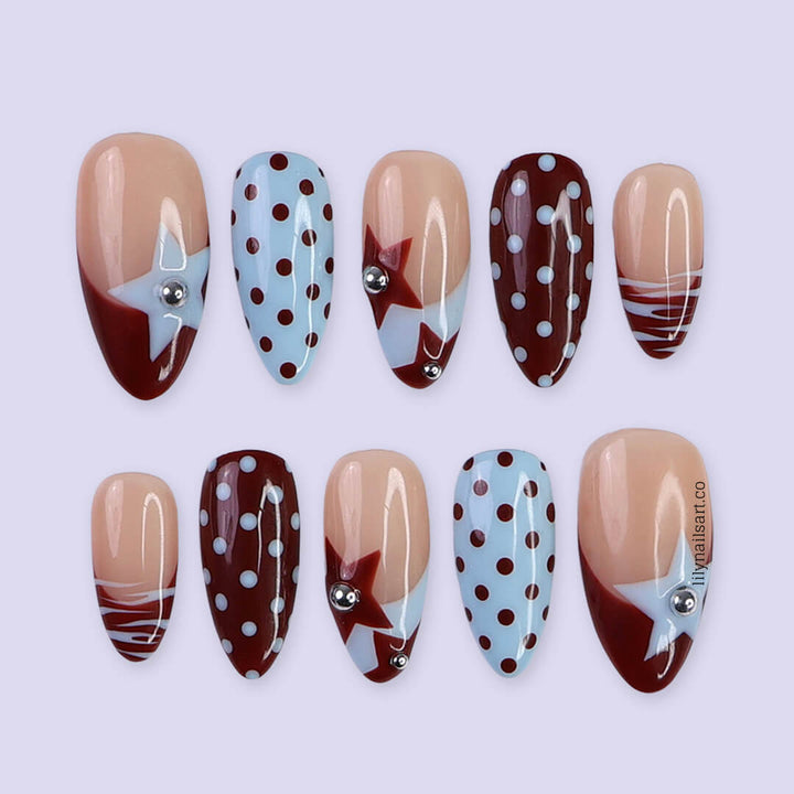 Handmade almond press on nails featuring a playful mix of burgundy polka dots, nude base with burgundy geometric tips, silver bead accents, and abstract line art. Retro-inspired, perfect for a bold and stylish look.
