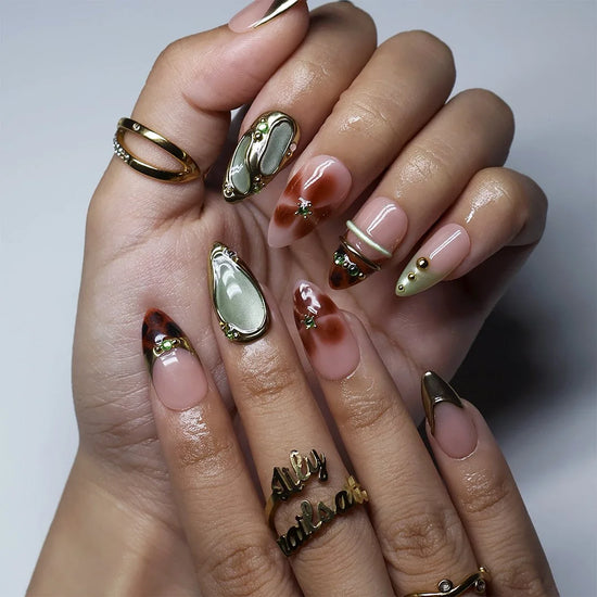 Warm brown and sage green almond press on nails worn on hand