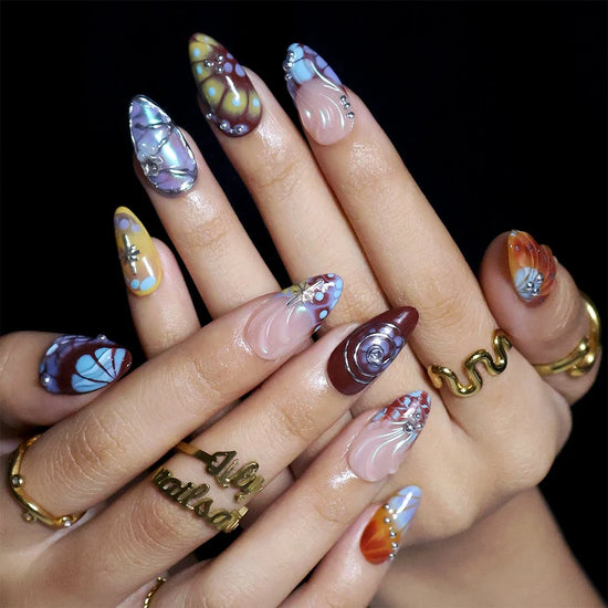 Asteria handmade Y2K press-on nails — almond set in caramel, brown and sky blue with silver chrome swirls, starbursts and marble effects