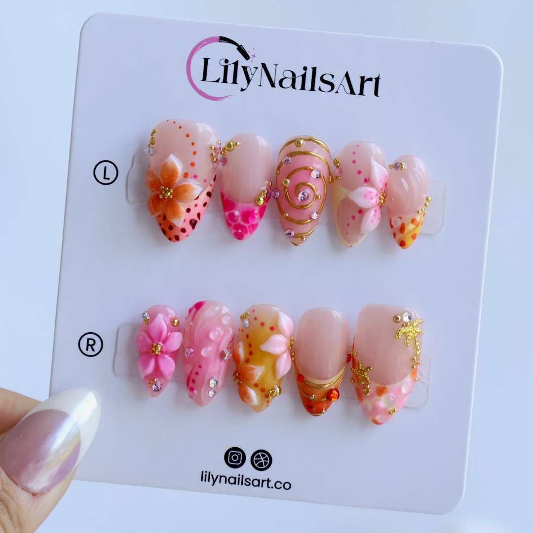Handmade summer press-on nails with coral pink blooms, 3D floral centerpiece, leopard dots and gold spiral details by Lily Nails Art