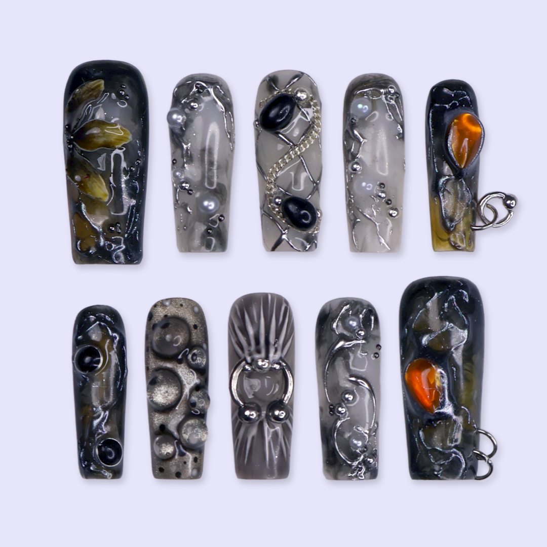 Alchemy gothic press on nails in smoky grey, black and olive with amber and onyx cabochons, silver hoops, chains and bubbling pearl textures — handmade Halloween press on nails, long square fake nails and witchy gothic nail art.
