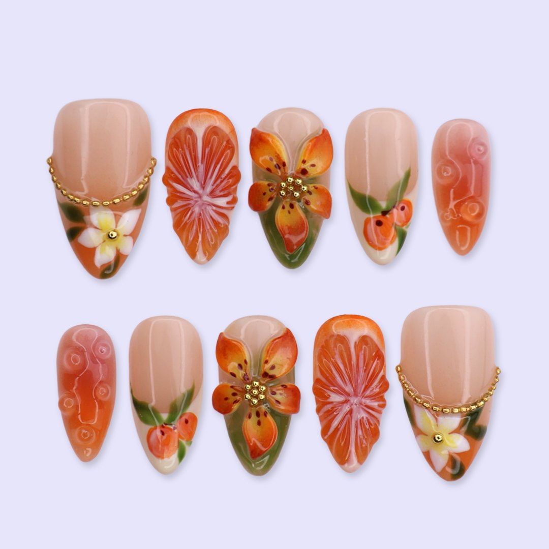 Handmade summer press-on nails with vivid citrus blooms, tropical floral art and gold bead embellishments by Lily Nails Art