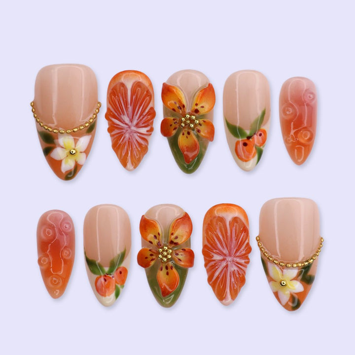 Handmade summer press-on nails with vivid citrus blooms, tropical floral art and gold bead embellishments by Lily Nails Art