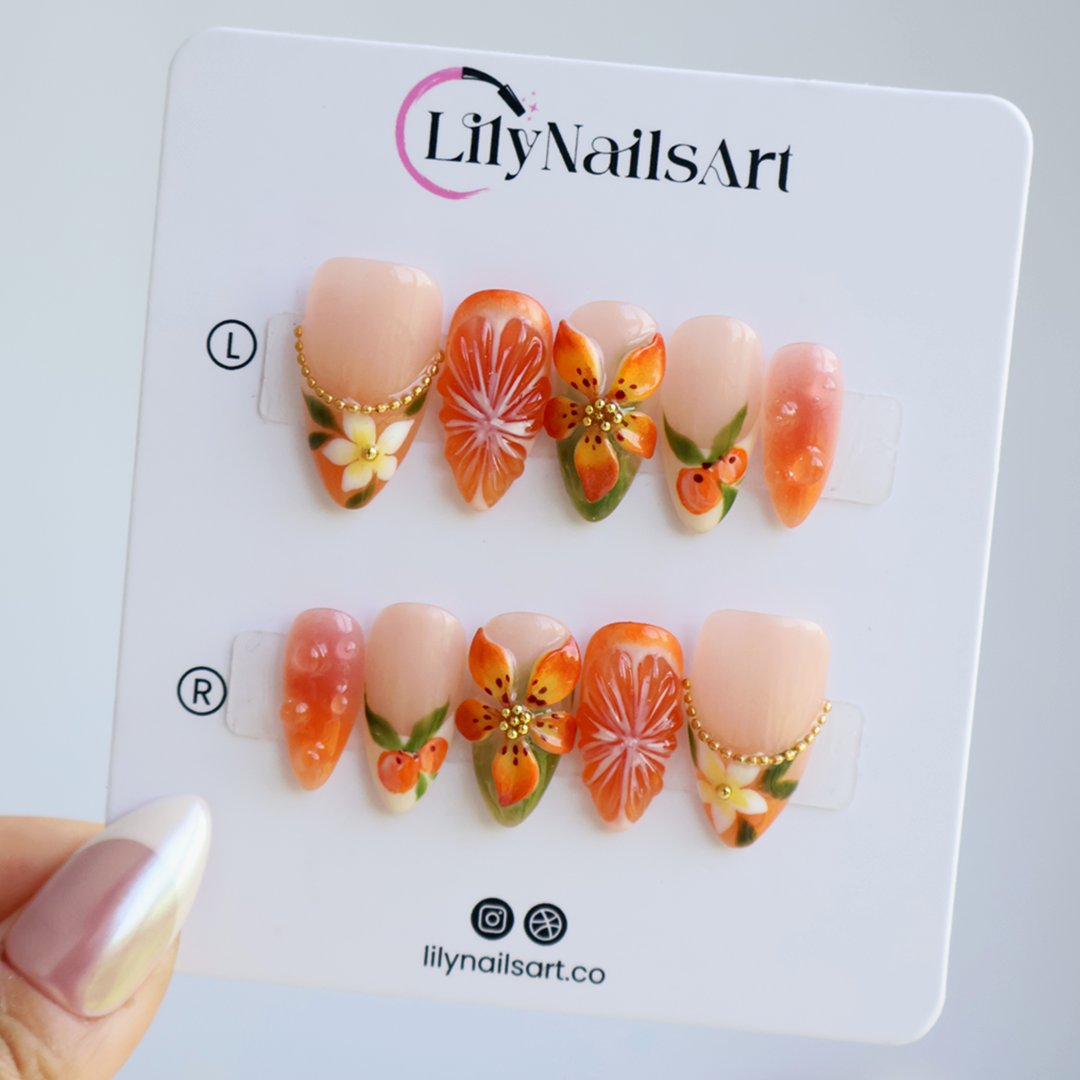 Handmade summer press-on nails with vivid citrus blooms, tropical floral art and gold bead embellishments by Lily Nails Art