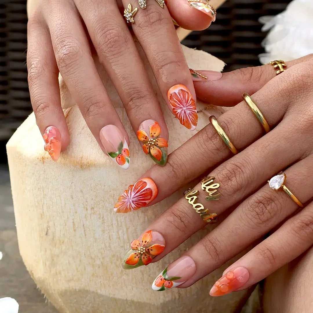 Handmade summer press-on nails with vivid citrus blooms, tropical floral art and gold bead embellishments by Lily Nails Art