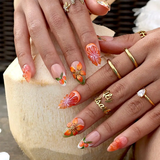 Handmade summer press-on nails with vivid citrus blooms, tropical floral art and gold bead embellishments by Lily Nails Art