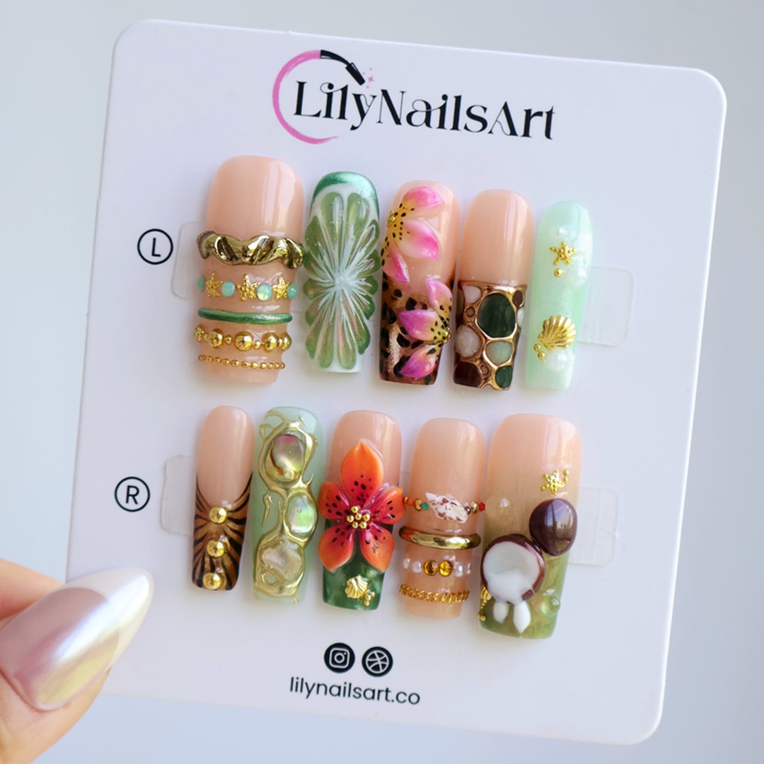 Handmade luxury summer press-on nails with tropical hibiscus, coconut art, 3D floral centerpiece and gold chain embellishments by Lily Nails Art