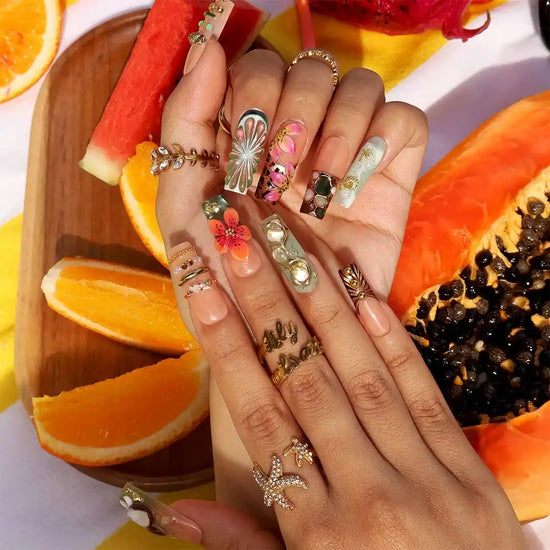 Handmade luxury summer press-on nails with tropical hibiscus, coconut art, 3D floral centerpiece and gold chain embellishments by Lily Nails Art