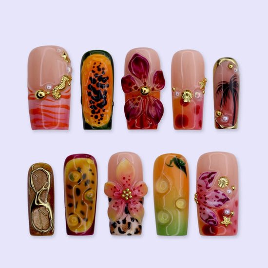 Handmade summer press-on nails with tiger lily blooms, leopard print and tropical fruit art by Lily Nails Art