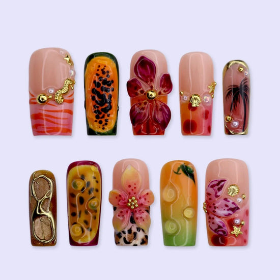 Handmade summer press-on nails with tiger lily blooms, leopard print and tropical fruit art by Lily Nails Art