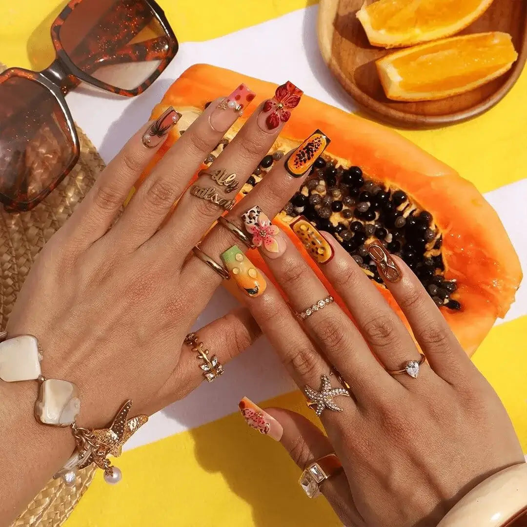 Handmade summer press-on nails with tiger lily blooms, leopard print and tropical fruit art by Lily Nails Art