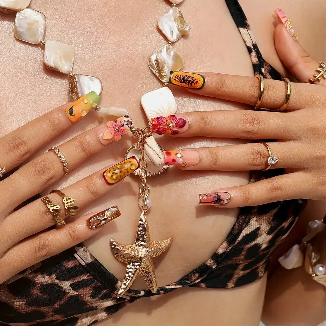 Handmade summer press-on nails with tiger lily blooms, leopard print and tropical fruit art by Lily Nails Art