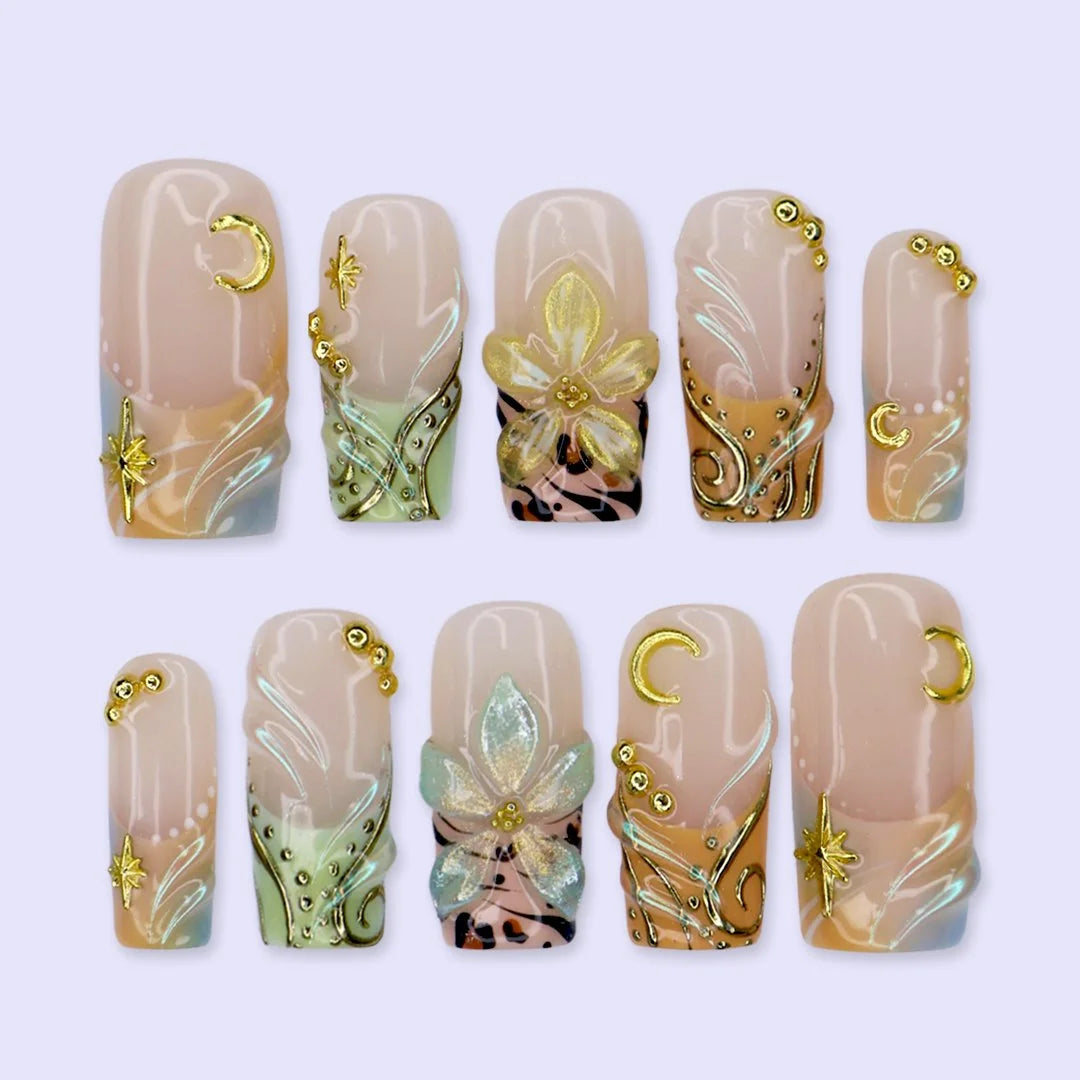 Handmade summer press-on nails with sage green botanical art, leopard print and gold moon and star charm embellishments by Lily Nails Art