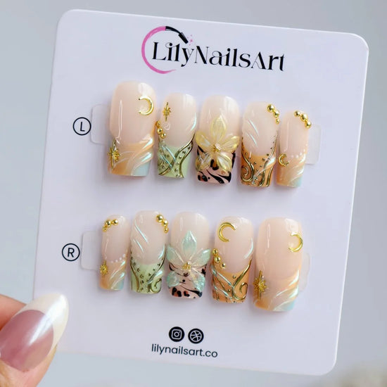Handmade summer press-on nails with sage green botanical art, leopard print and gold moon and star charm embellishments by Lily Nails Art