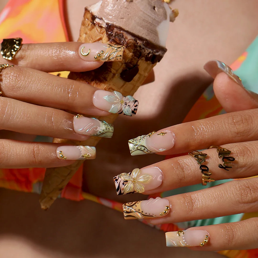 Handmade summer press-on nails with sage green botanical art, leopard print and gold moon and star charm embellishments by Lily Nails Art