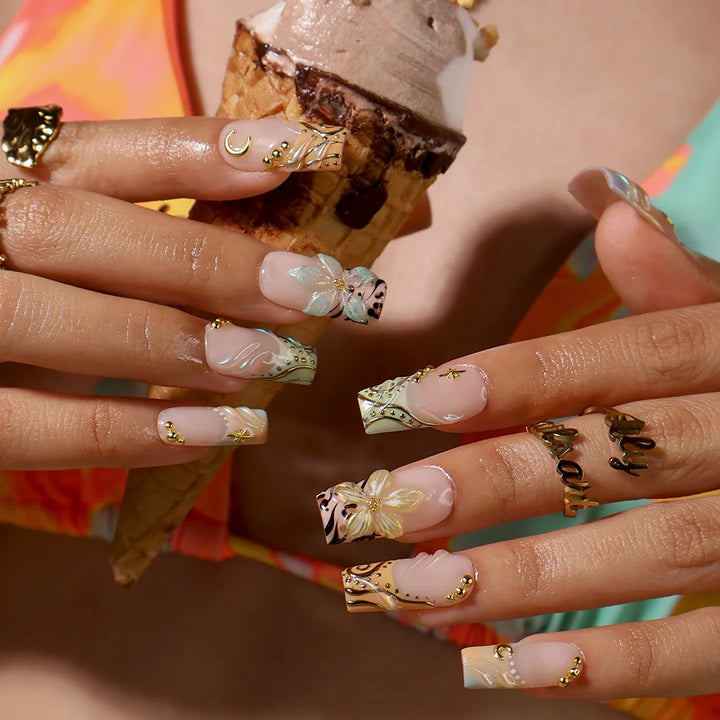 Handmade summer press-on nails with sage green botanical art, leopard print and gold moon and star charm embellishments by Lily Nails Art