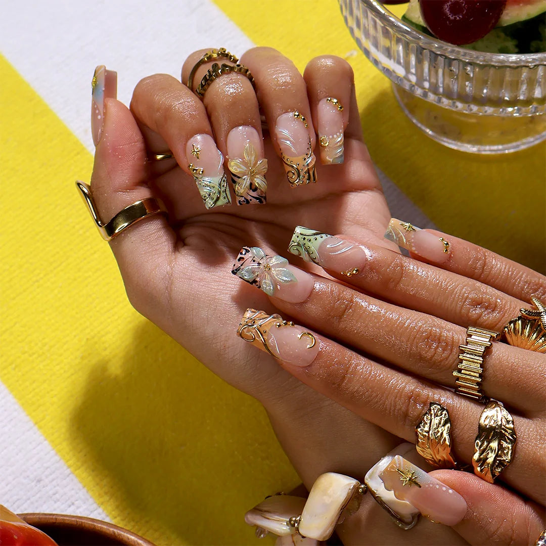 Handmade summer press-on nails with sage green botanical art, leopard print and gold moon and star charm embellishments by Lily Nails Art