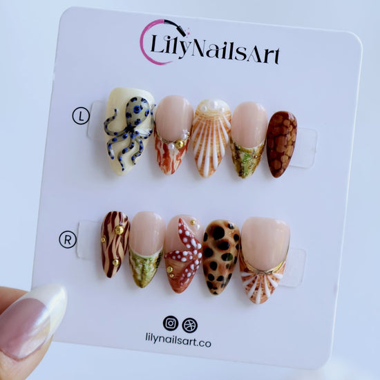 Handmade summer press-on nails with seashell art, blue-ringed octopus, starfish and leopard cowrie print by Lily Nails Art