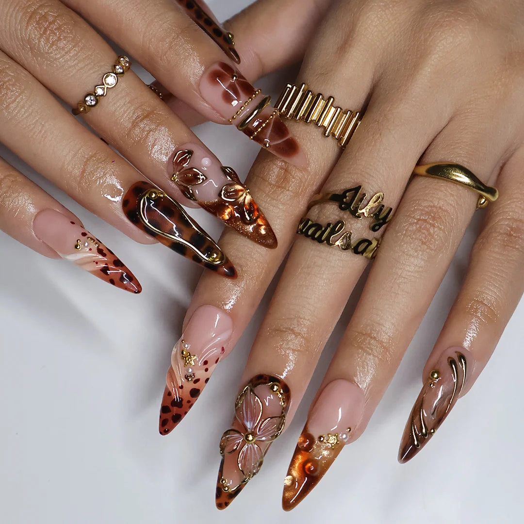 Cognac handmade fall press-on nails — almond set in nude and tortoiseshell brown with gold 3D lilies, wire-work and leopard print
