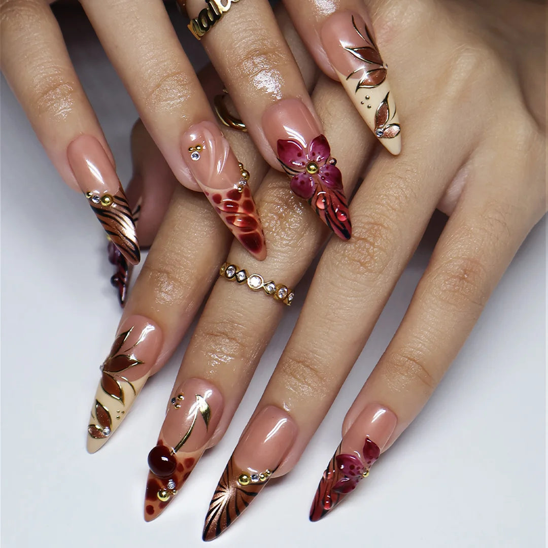 Marsala handmade fall press-on nails — long almond set in nude and plum-magenta with 3D lilies, gold cat-eye petals and berry details