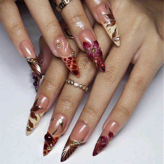Marsala handmade fall press-on nails — long almond set in nude and plum-magenta with 3D lilies, gold cat-eye petals and berry details