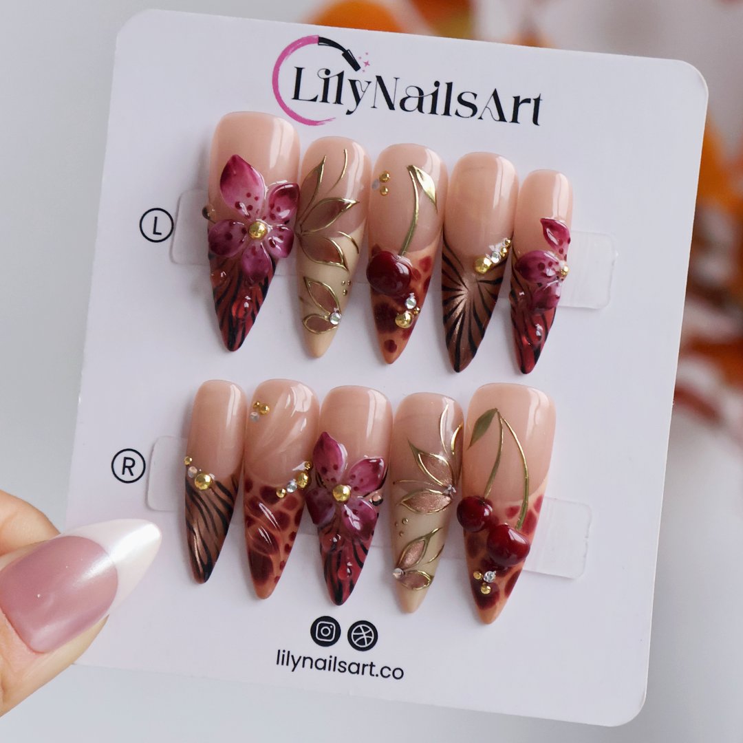 Marsala handmade fall press-on nails — long almond set in nude and plum-magenta with 3D lilies, gold cat-eye petals and berry details