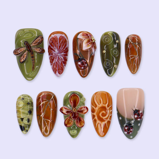 Wildwood handmade fall press-on nails — almond set in olive green, rust and terracotta with 3D dragonfly, ladybugs, orchids and gold leaf-vein linework