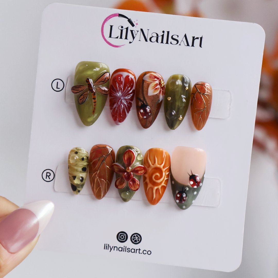 Wildwood handmade fall press-on nails — almond set in olive green, rust and terracotta with 3D dragonfly, ladybugs, orchids and gold leaf-vein linework