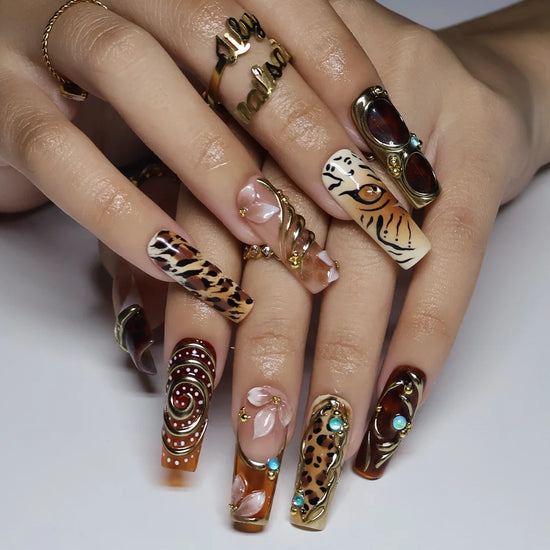 Safari handmade fall press-on nails — long square set in nude, caramel and amber with leopard, tiger print, gold swirls and gems