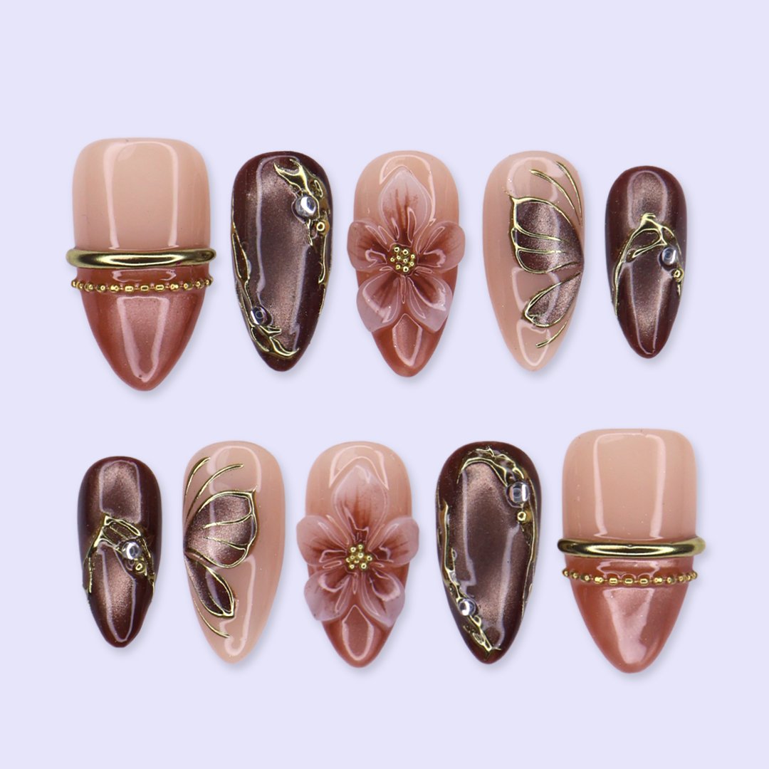 Papillon handmade fall press-on nails — almond set in nude, mauve and chocolate cat-eye with 3D pink lilies and gold butterfly-wing linework