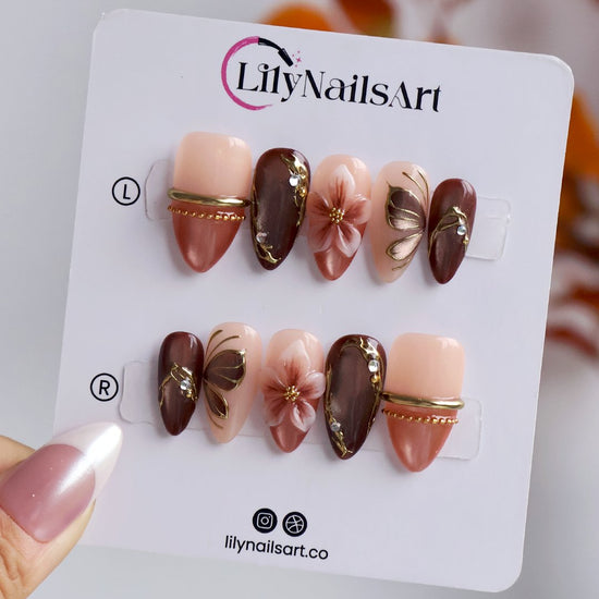 Papillon handmade fall press-on nails — almond set in nude, mauve and chocolate cat-eye with 3D pink lilies and gold butterfly-wing linework