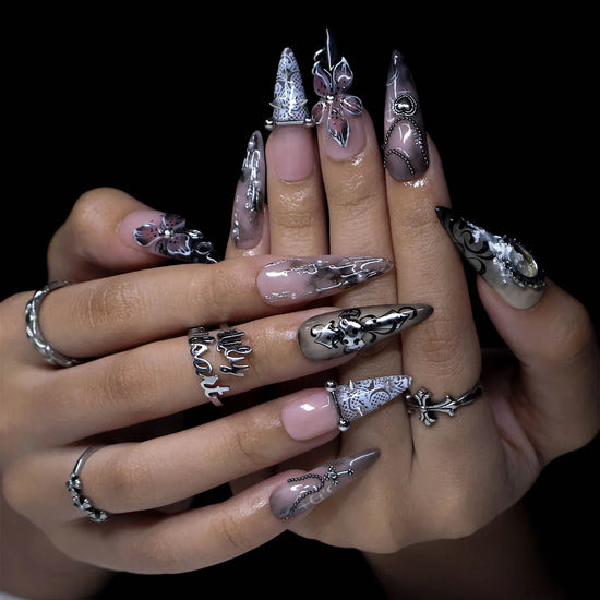 Gothic press on nails in black and nude with 3D crosses, silver metallic details and dark crystal embellishments — handmade Halloween press on nails, long almond fake nails and gothic nail art.